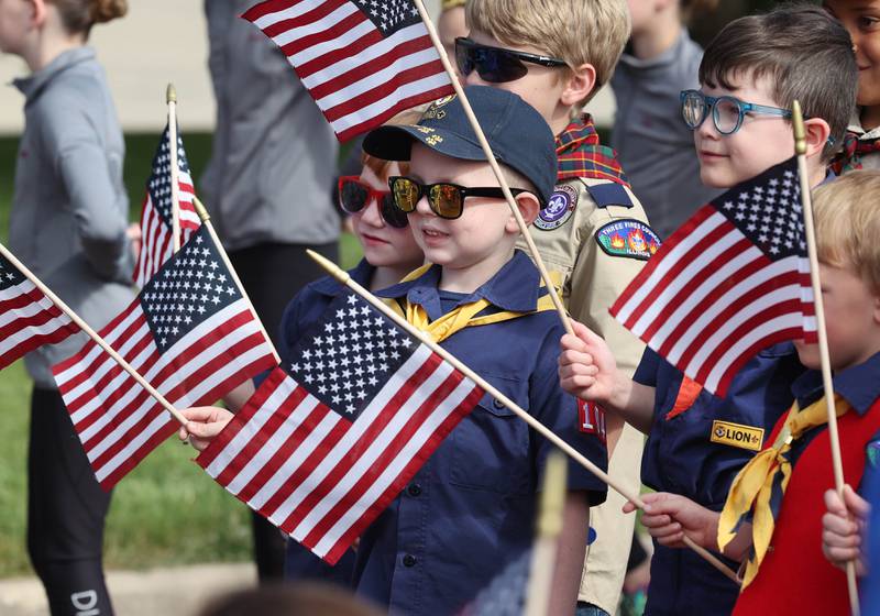 Cub Scout Calvin McCarthy, (center) of DeKalb, along with his fellow scouts get ready to march Monday, May 29, 2023, in the DeKalb Memorial Day parade.