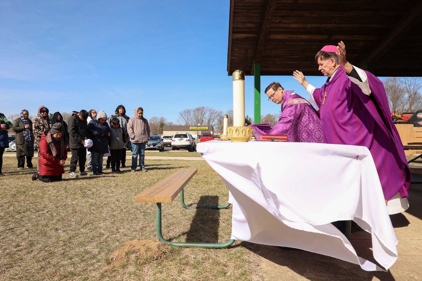 Bishop Chris Glancy, of St. Patrick’s Catholic Church, right, and Rev. Matt Pratscher, of St. John Paul II Catholic Church, lead a Mass and prayer service held in Aroma Park on Thursday, March 12, 2026, following the EF-3 tornado that tore through the town and Kankakee County on March 10.