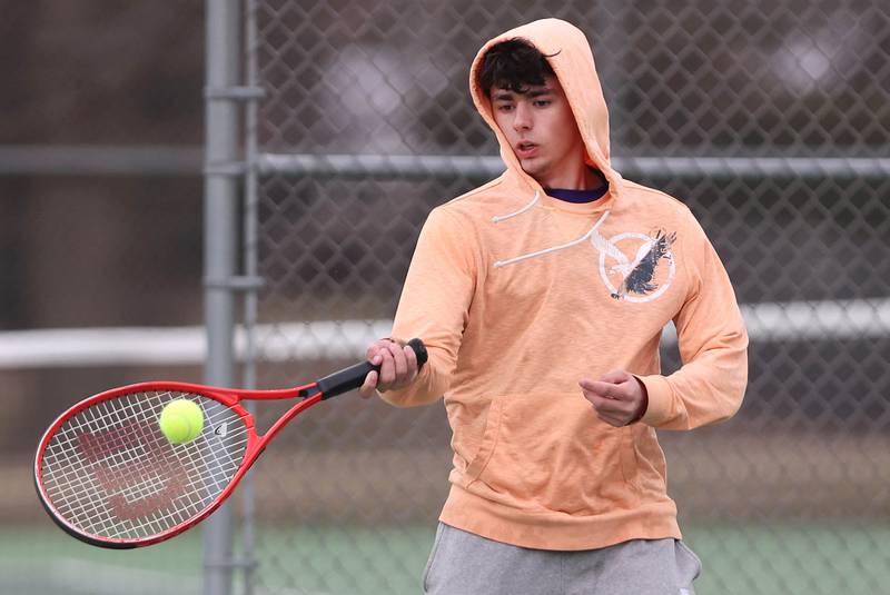 Dixon’s number two singles player Damien Beck hits a forehand during his match against Sycamore Thursday, March 30, 2023, at Sycamore High School.