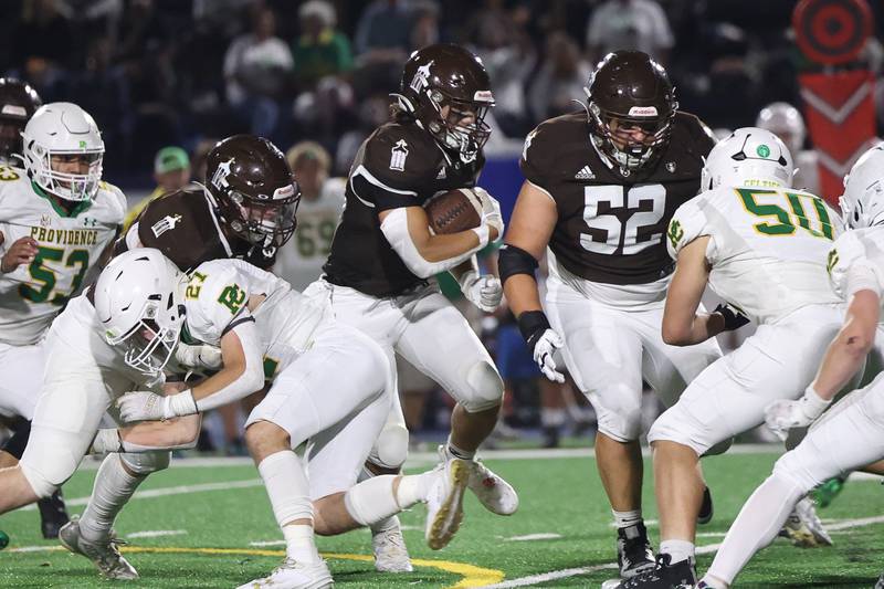 Joliet Catholic’s Nate Magrini finds a hole on a run against Providence on Friday, Sept. 1, 2023 Joliet Memorial Stadium.