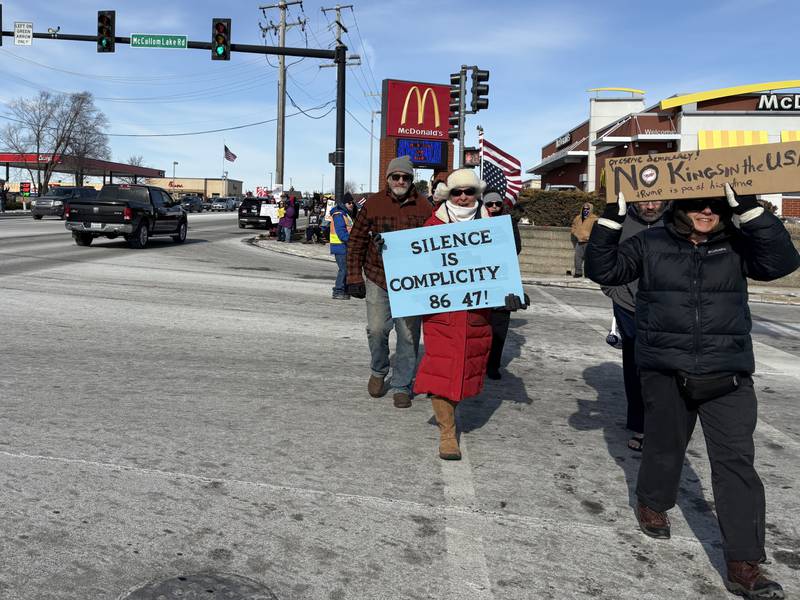 Protesters walk with signs during a protest in McHenry Feb. 1, 2026.