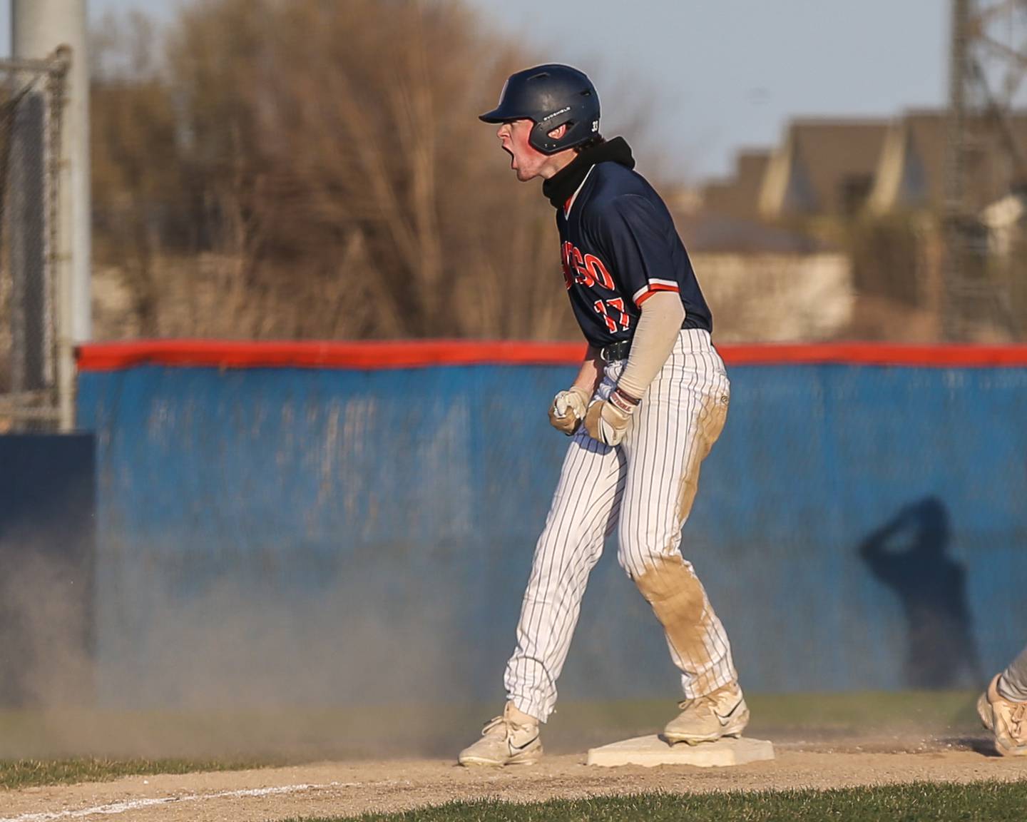 Oswego's Jacob Fehrmann (17) screams into the dugout after pulling up to third for a triple, knocking in a pair of runs during baseball game between Plainfield South at Oswego on Monday, April 14, 2025 in Oswego.