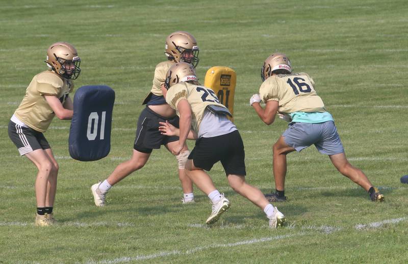 Members of the Marquette football team practice during football camp on Monday, July 24, 2023 on the practice field next to Gould Stadium in Ottawa.