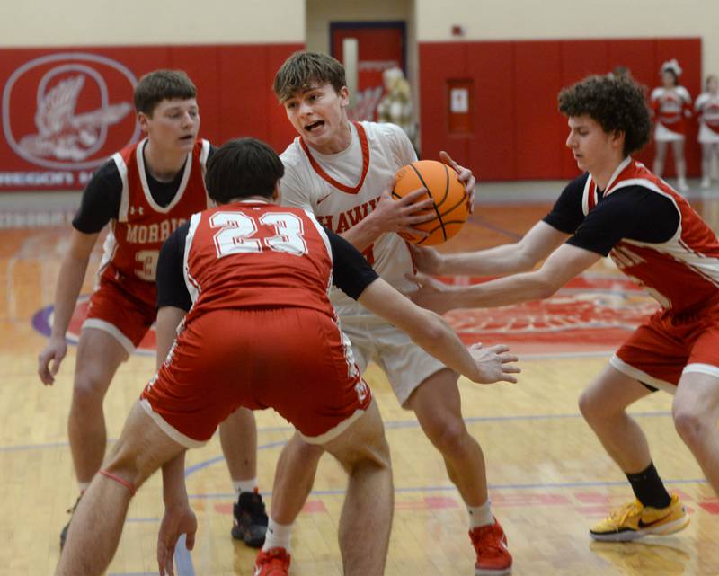 Oregon's Cooper Johnson (3) draws a trio of Morrison defenders on Saturday, Jan. 11, 2025 at the Blackhawk Center in Oregon.
