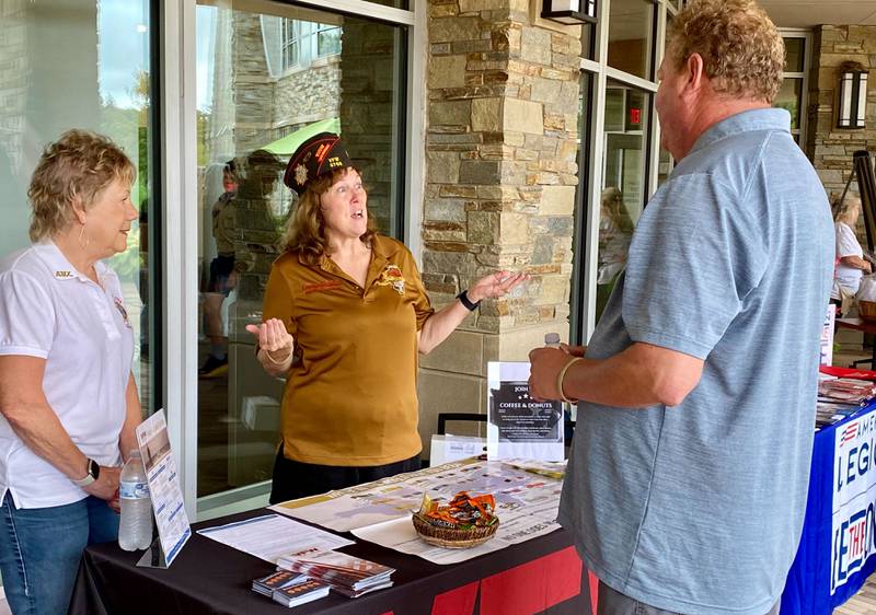 U.S. Army veteran Laurie Emmer (middle) speaks to a participant at the Sycamore VFW table during the inaugural Be the One Walk, a 2.2-mile trek hosted by DeKalb area veterans groups to raise awareness of veteran resources in the community and combat veteran suicide rates. Emmer is also on the DeKalb County Board and was the first woman to command the Illinois VFW.