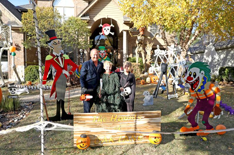 Mark Licht (left), son Noah, 10, (center) and wife, Laura (right), are in their sixth year of competing in the St. Charles Park District Halloween decorating competition at their home, which is located in the Thornwood subdivision in South Elgin.
