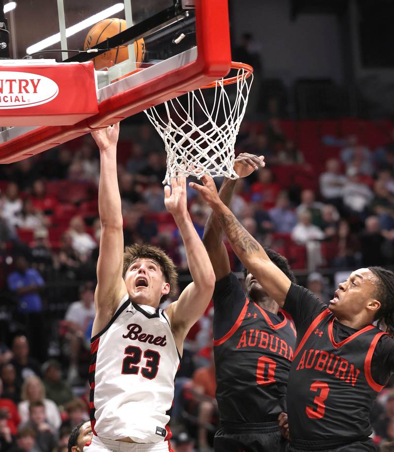 Benet’s Edvardas Stasys scores in front of two Auburn defenders Monday, March 9, 2026, during their IHSA Class 4A supersectional matchup in the Convocation Center at Northern Illinois University in DeKalb.