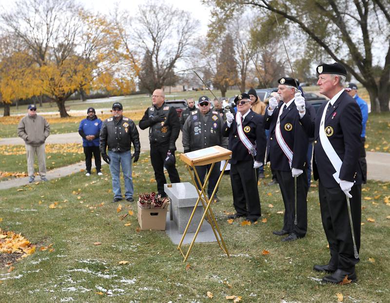 Swords are raised as “Taps” is played during the Veterans Day flag placement ceremony Tuesday, Nov. 11, 2025, at the gravesites of veterans at McHenry County Memorial Park Cemetery in Woodstock. Members of the Knights of Columbus Patriotic 4th Degree from the Bishop Boylan Assembly placed American Flags at nearly 140 veterans' grave markers.