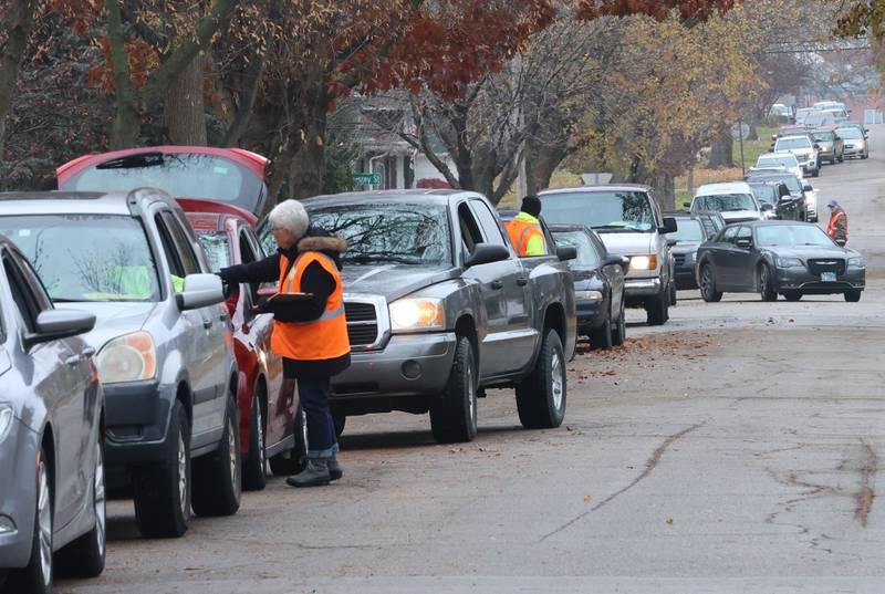 A ong line of traffic waits at at the corner of 1st and Terry Street during the Thanksgiving distribution on Wednesday, Nov. 19, 2025 at the Hall Township Food Pantry in Spring Valley. Nearly 500 families will receive food from this years distribution.