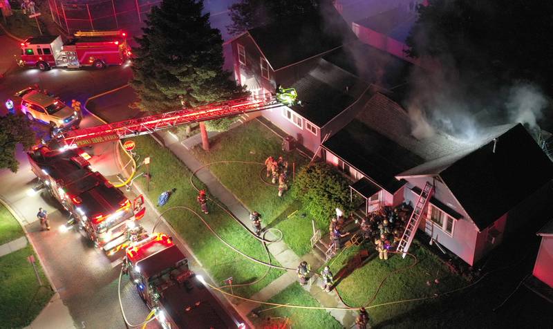 Firefighters work the scene of a structure fire in the 100 block of West Cleveland Street on Thursday, May 15, 2025 in Spring Valley. The fire broke out shortly before 8:30p.m. Fire departments from La Salle Bureau and Putnam Counties responded to the scene. A mutual aid box alarm system (MABAS) call was issued prompting the response.