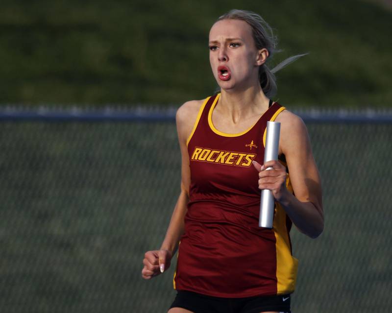 Richmond-Burton’s Sydney Frericks crest to the finish line as she run the last leg of th 4X200 meter relay during the Kishwaukee River Conference Girls Track and Field Meet on Tuesday, May 5, 2025, at Woodstock High School.