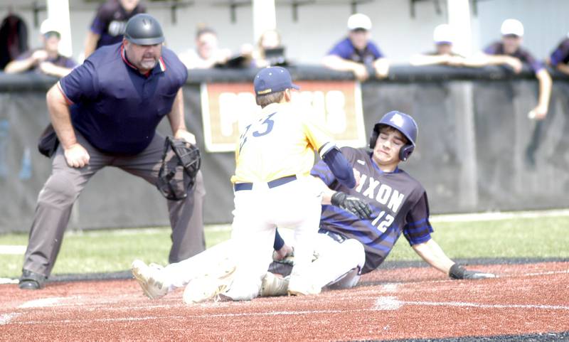 Gage Helfrich is tagged at home by Sterlings Mason Hubbard. Dixon defeated Sterling 10-2 to win the Freeport regional in Freeport on May 31st, 2025.