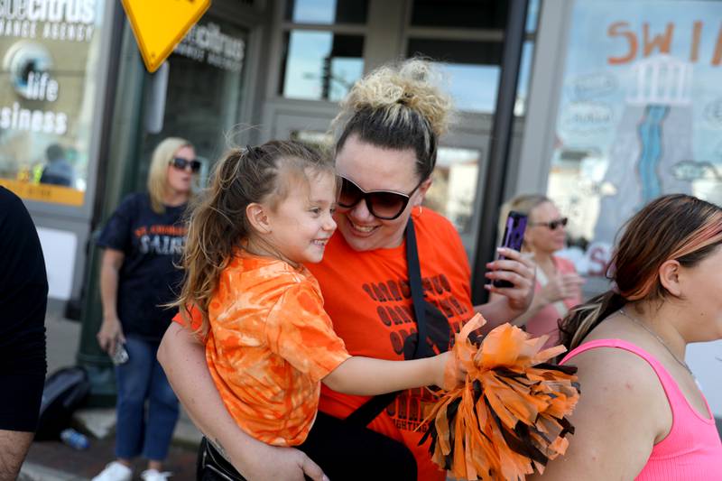 Jessica Sanchez of St. Charles and her daughter, April, 4, watch the St. Charles East High School homecoming parade on Friday, Sept. 13, 2024 on Main Street in St. Charles.