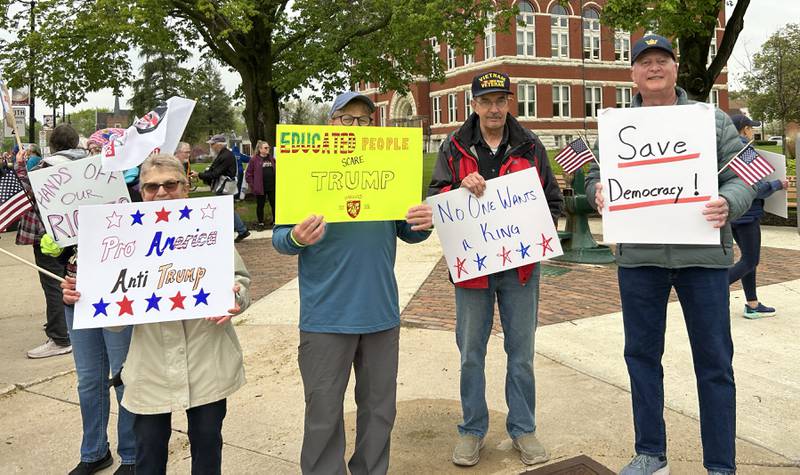Attendees held signs at the May Day Rally on Thursday, May 1, 2025 in Oregon. The evening event was held around the historic Ogle County Courthouse.