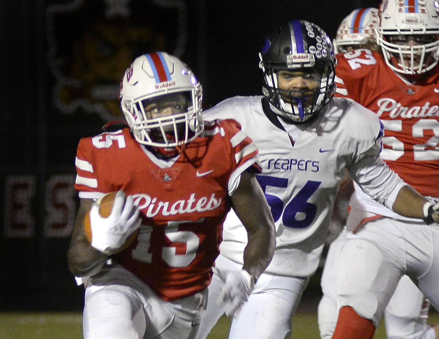 Ottawa’s Javarius Whitfield (15) gets past Plano’s Arik Harrelson on a run Friday, Oct. 22, 2021, in Ottawa.