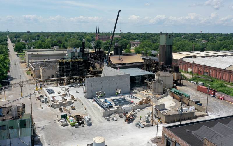 Crews are rebuilding a foundation in the area where a massive fire broke out in 2022 at Carus Chemical on Monday, June 3, 2024 in La Salle. Here, an aerial view shows a large crane currently at the site hoisting building materials for concrete walls.