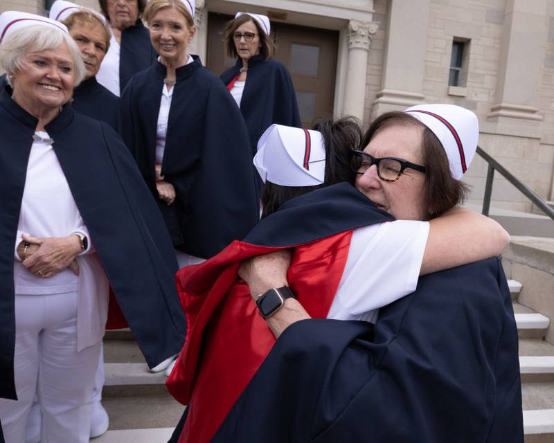 Lisa Buckley hugs her mentor Shirley Eide  (right) after the group photo for the newly formed Illinois Valley Nurse Honor Guard at the Holy Rosary Memorial Shrine on May 21, 2025 in LaSalle.