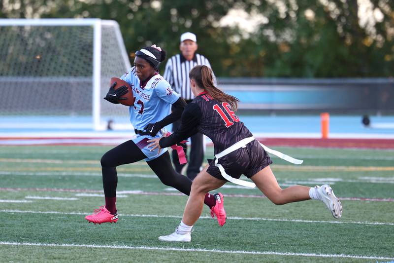 Kankakee's Kamryn Pullins tries to evade Yorkville's Hayden Hodges during the Foxes' 26-13 victory over Kankakee on Tuesday, Oct. 7, 2025.