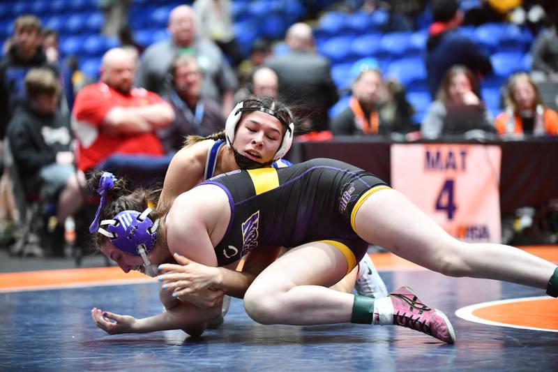 Sophia Ball of Hoffman Estates, top, wrestles in the 130-pound championship match in the IHSA Girls Individual State Finals on Saturday, March 1. Ball took first place over Kinnley Smith of Canton.