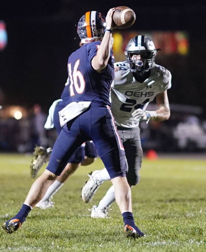 Oswego East's Christian Martyn (24) blitzes Oswego’s Brett Connolly (16) during a football game at Oswego High School on Friday, Oct. 20, 2023.