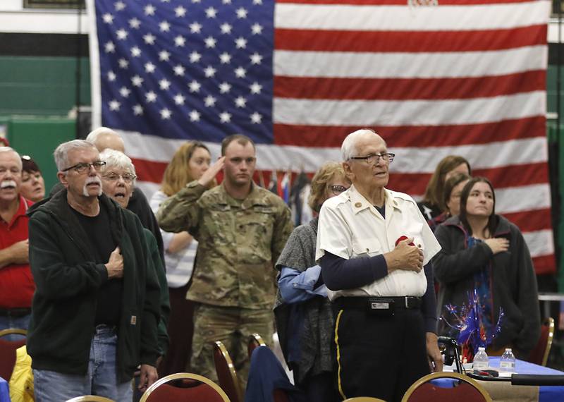 Veterans and their families stand as the Colors are Posted during the Veterans Day ceremony Wednesday, Nov.8, 2023, at Alden-Hebron High School in Hebron.