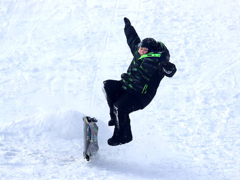 Riley Gumprecht, 8, of Woodstock launches off a jump at Emricson park Saturday in the wake of overnight snow.