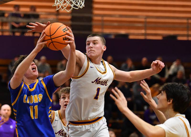 Lyons Township’s Tommy Blyth grabs a rebound just out of reach of Downers Grove North’s Colin Doyle (1) during a game on January 15, 2026 at Downers Grove North High School in Downers Grove .