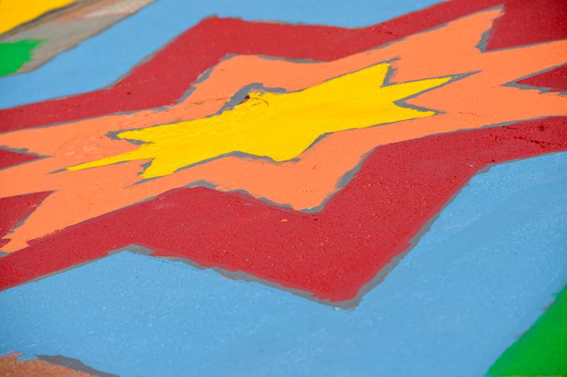 A multi colored street mural comes to life in the intersection of Walnut and Riverside Avenues during the St. Charles Art CouncilÕs ÒPaint the RiversideÓ event on Saturday, May 10, 2025 in St. Charles.