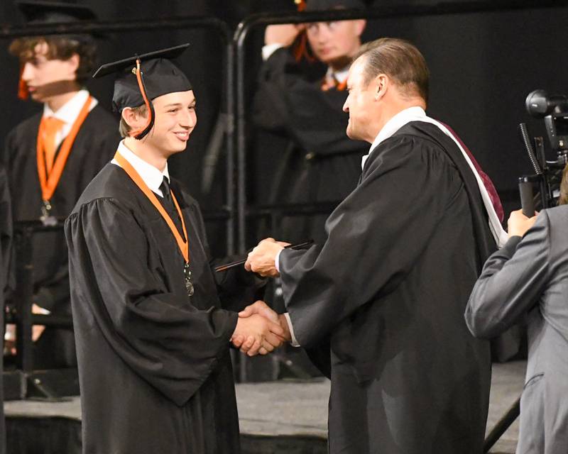 A St. Charles East graduate accepts walks across the stage on Monday May 18, 2026, at the Convocation Center in DeKalb.