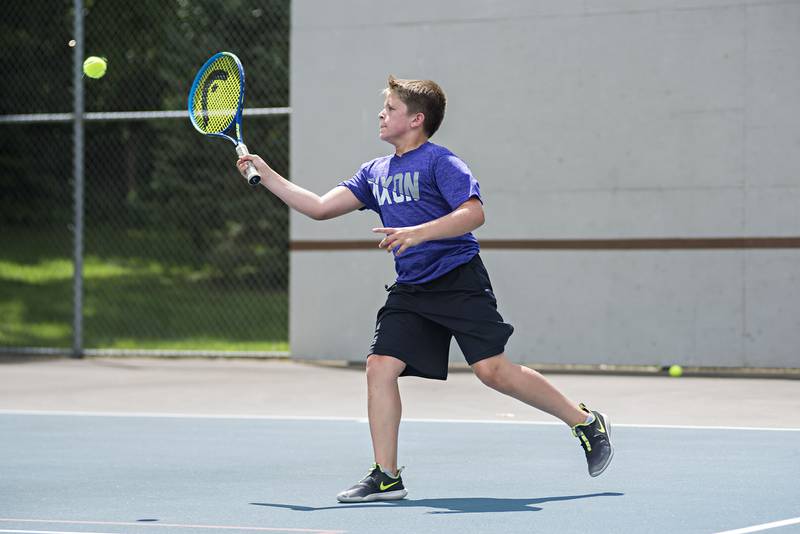 Cameron Foulker returns a shot while playing in the 15 and under boys single tournament during the Emma Hubbs tennis classic in Dixon.