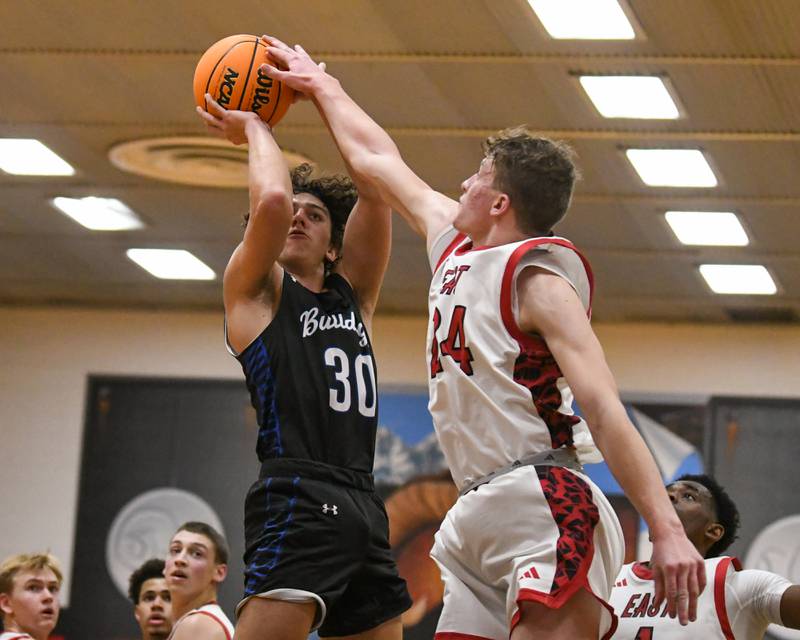 Riverside Brookfield's Liam Enright (30) makes a shot while being defended by Glenbard East's Sam Walton (24) during the game on Friday Dec. 19, 2025, held at Glenbard East High School.