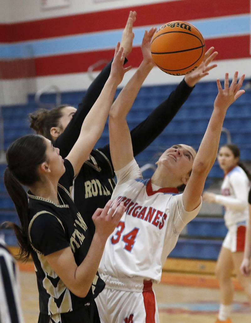 Marian Central's Juliette Huff (right) battles for a rebound with Rockford Christian's Josie Becker (left) and Teagan Lawver (center) during a nononference basketball game on Monday, Feb. 10, 2025, at Marian Central High School  in Woodstock.
