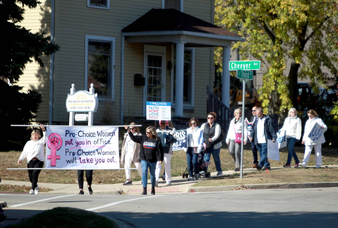 Participants of the Roe the Vote and March to the Polls walk from the Kane County Courthouse to the Kane County Clerk’s office in Geneva on Tuesday, Oct. 15, 2024.
