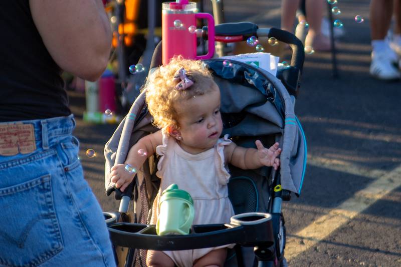 A child plays with bubbles Friday, Aug. 23, 2024, at Family Safe Night outside of the Mendota Civic Center.