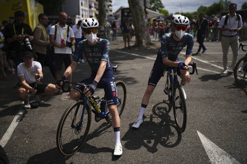 FILE - Denmark's Jonas Vingegaard, left, and teammate Matteo Jorgenson, of the U.S., wear face masks to protect themselves from the Corona virus prior to the start of the fourteenth stage of the Tour de France cycling race over 151.9 kilometers (94.4 miles) with start in Pau and finish in Saint-Lary-Soulan Pla d'Adet, France, July 13, 2024.  (AP Photo/Daniel Cole, File)