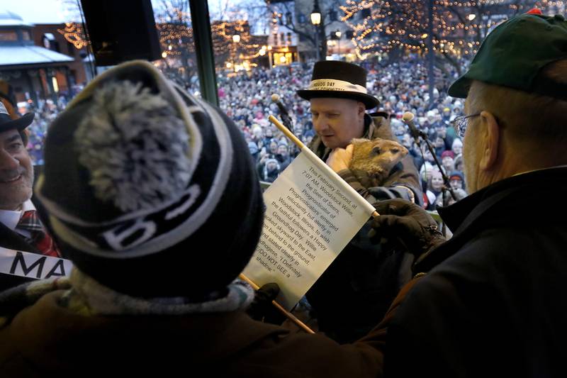 Woodstock Willie held by handler Mark Szafran speaks in groundhogese as Willie tells officials that he did not see his shadow a on Sunday, Feb. 2, 2025, bringing an early spring during the annual Groundhog Day Prognostication in the Woodstock Square.