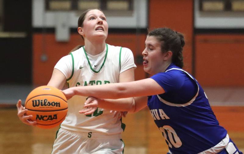 Crystal Lake South’s Gaby Dzik, left, works past Geneva’s Keira McCann in girls IHSA Class 3A Sectional Championship basketball on Thursday, Feb. 26, 2026, at Crystal Lake Central High School in Crystal Lake.