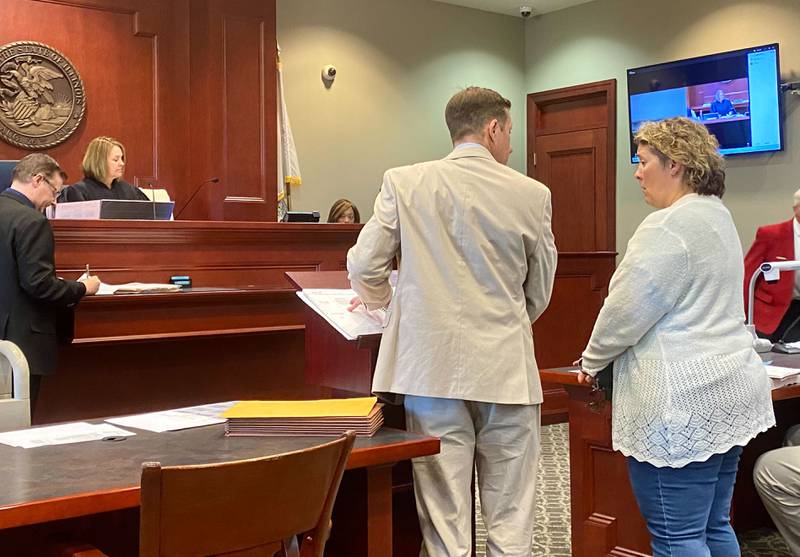Deborah J. Baugus, 50, of Sycamore (right) stands with her defense attorney Dan Transier (middle) as Circuit Court Judge Marcy Buick (second from left) presides from the DeKalb County Courthouse Monday, July 15, 2024. Joseph Hodder (left) of the DeKalb County State's Attorney's Office is prosecuting. Baugus is charged with felony theft after prosecutors alleged that she stole about $90,000 in funds from the Sycamore Music Boosters Club while she was its treasurer between 2017 and 2023, according to DeKalb County court records.