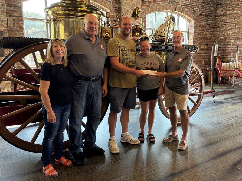 (From left) Brad Baker, Andy and Kala Bormet and Guy Christensen at the Morris Fire Station on Friday, Aug. 15, 2025.