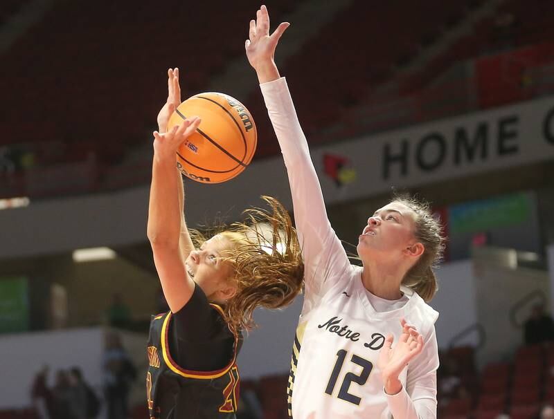 Montini's Audrey Kinney looses control of the ball in the lane as Quincy Notre Dame's Lauren Hummel defends during the Class 3A State semifinal game on Thursday, March 6, 2025 at CEFCU Arena in Normal.