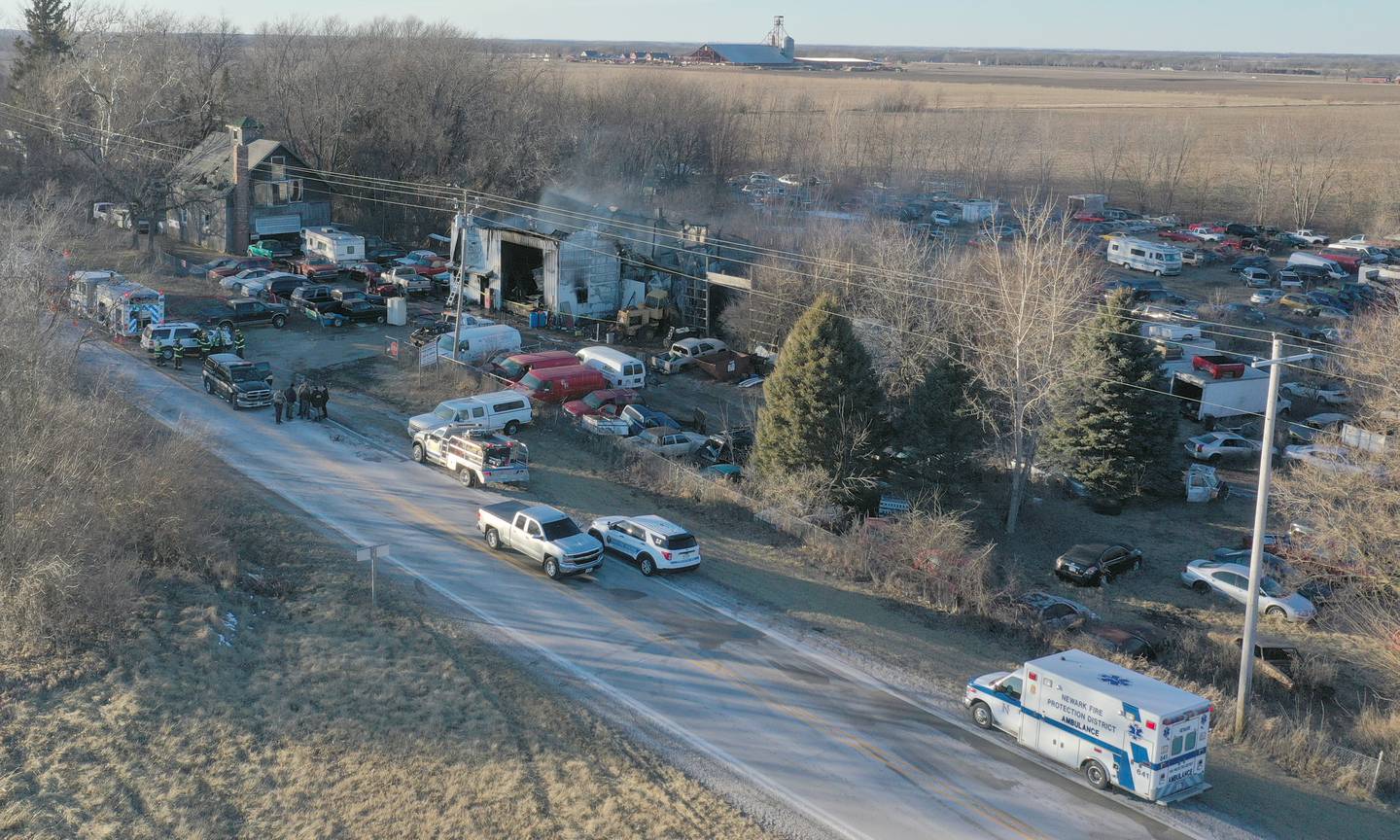 Newark Fire and EMS along with La Salle County Sheriff deputies work the scene of a fire at Harpers Used Cars and Towing on Tuesday, Jan. 25, 2025 in Sheridan. Here, the Illinois State Fire Marshal and La Salle County Sheiff deputies work the scene of the fire.