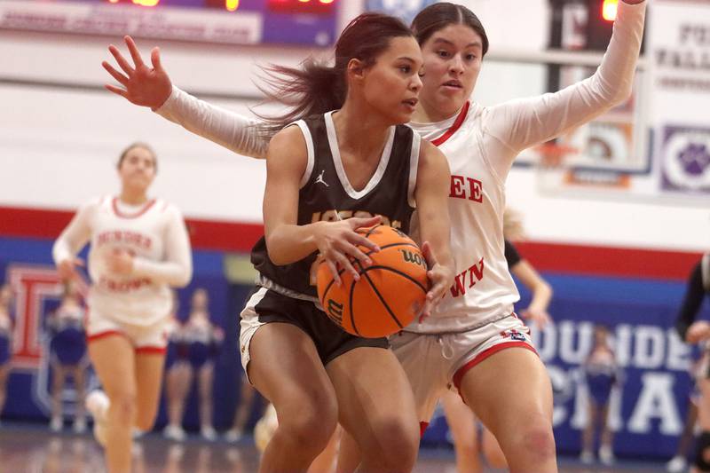 Jacobs’ Jordyn Dillard, left, works under the hoop as Dundee-Crown’s Ashley Castro defends in varsity girls basketball on Friday, Dec. 12, 2025, at Dundee-Crown High School in Carpentersville.