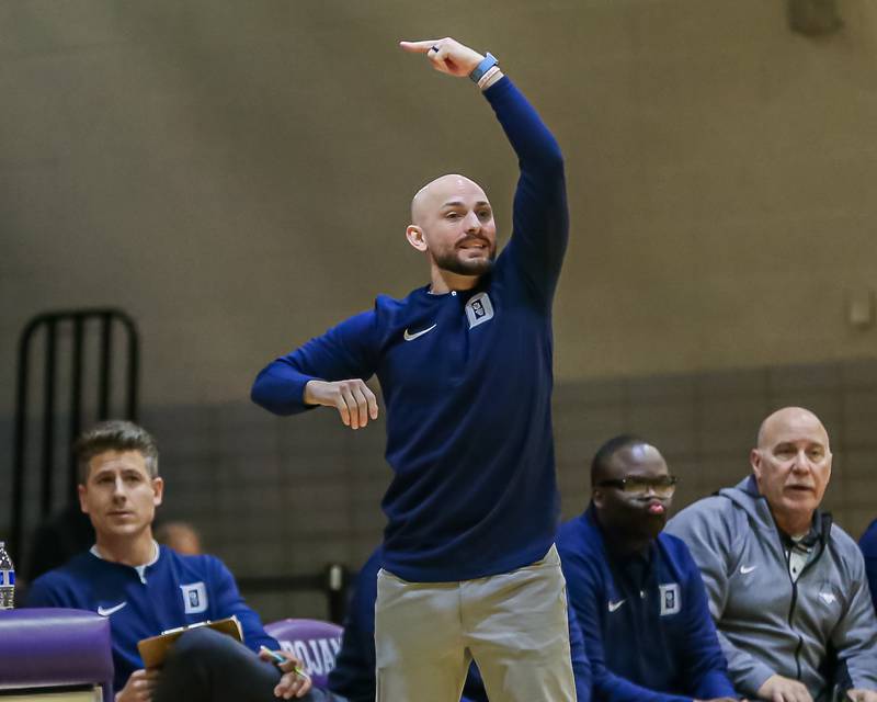 Downers Grove South's head coach Zach Miller calls out a play during basketball game between Downers Grove South at Downers Grove North. Dec 16, 2023.