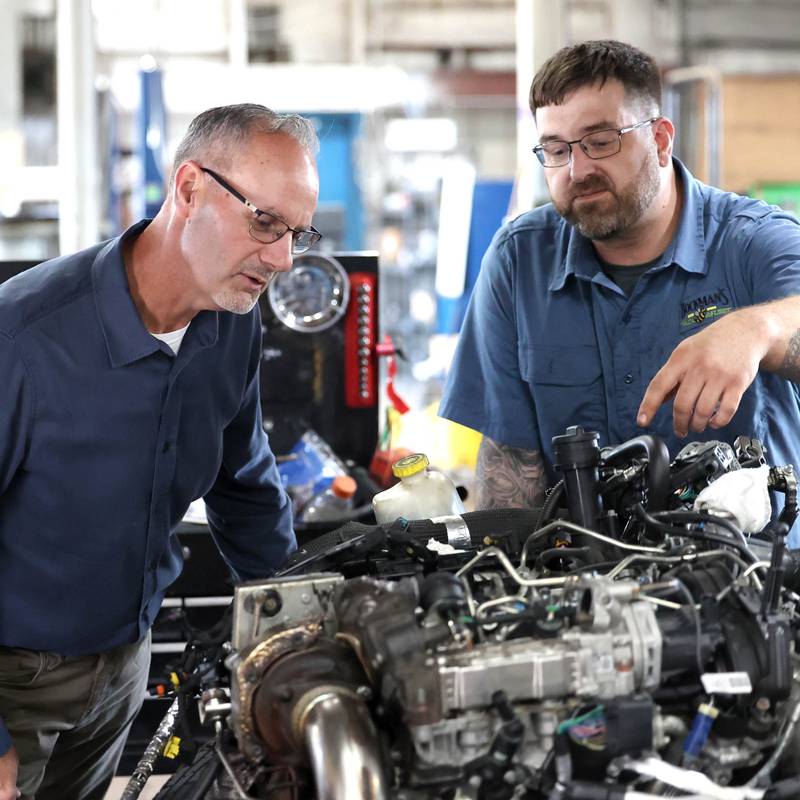 Jon Bockman, (left) owner of Bockman’s Auto, Truck & Tire, looks over a motor with lead technician Adam Zonka Friday, Aug. 2, 2024, at the DeKalb location on Industrial Drive.