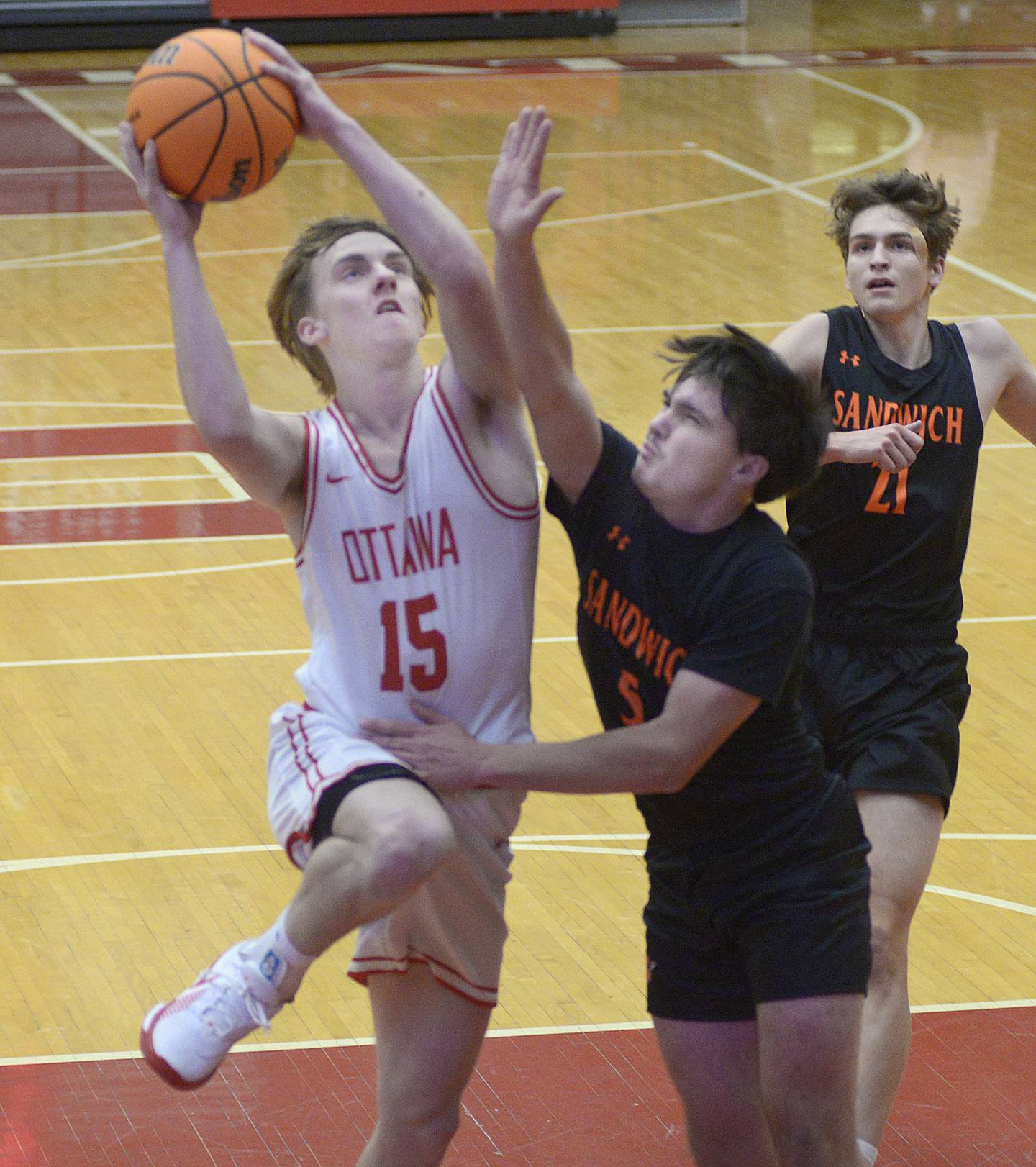 Ottawa’s Blake Schmitz works to drive past Sandwich’s Griffin Somolock in the 1st period Tuesday at Ottawa.