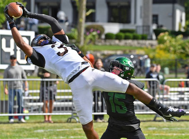 Joliet Catholic’s Jayden Armstrong (3) makes a touchdown catch in the end zone as Glenbard West’s Bryce Ellens defends during a game on September 6, 2025 at Glenbard West High School in Glen Ellyn.