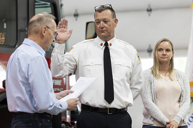 Dixon Rural’s Derrick Storey is sworn in as assistant fire chief Tuesday, May 14, 2024 by board president Brian Mayer.