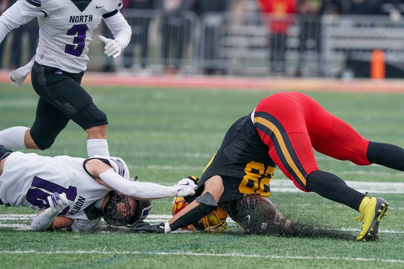 Downers Grove North's Oliver Thulin (10) tackles Batavia’s Nathan Whitwell (28) during a class 7A quarterfinal playoff football game at Batavia High School on Saturday, Nov. 16, 2024.