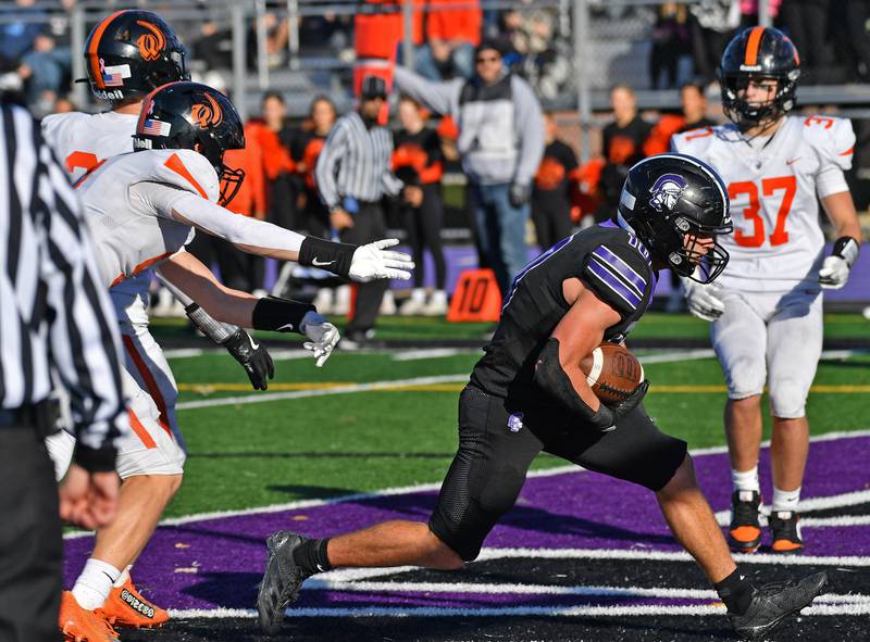 Downers Grove North’s Oliver Thulin shoots into the end zone with at touchdown during a Class 7A quarterfinal game against Lincoln-Way West on November 15, 2025 at Downers Grove North High School in Downers Grove .