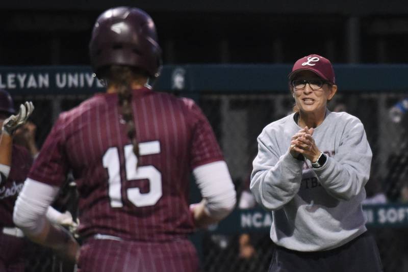 Lockport softball coach Marissa Chovanec, right, hypes up the Porters' Liliana Janeczko before her at-bat in the seventh inning of the Class 4A Illinois Wesleyan Supersectional against Bradley-Bourbonnais Monday, June 9, 2025.